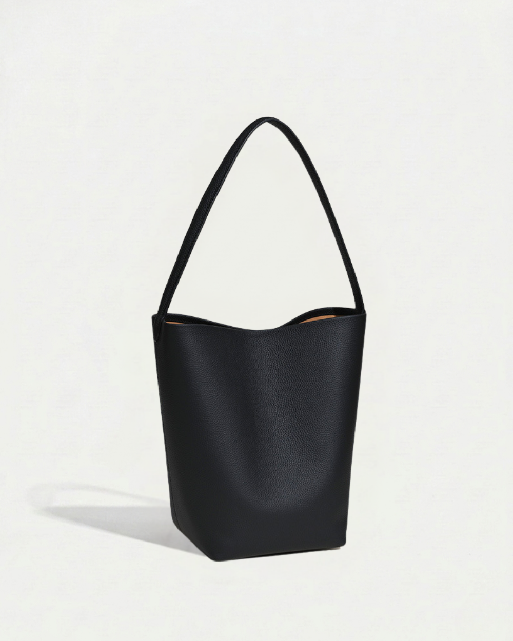 Léa Bucket Bag in black pebbled cowhide, side profile