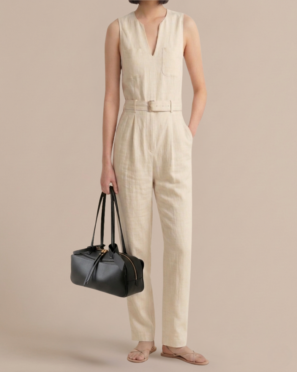 Woman carrying the Amélie Bowling Bag in black leather, showing full body